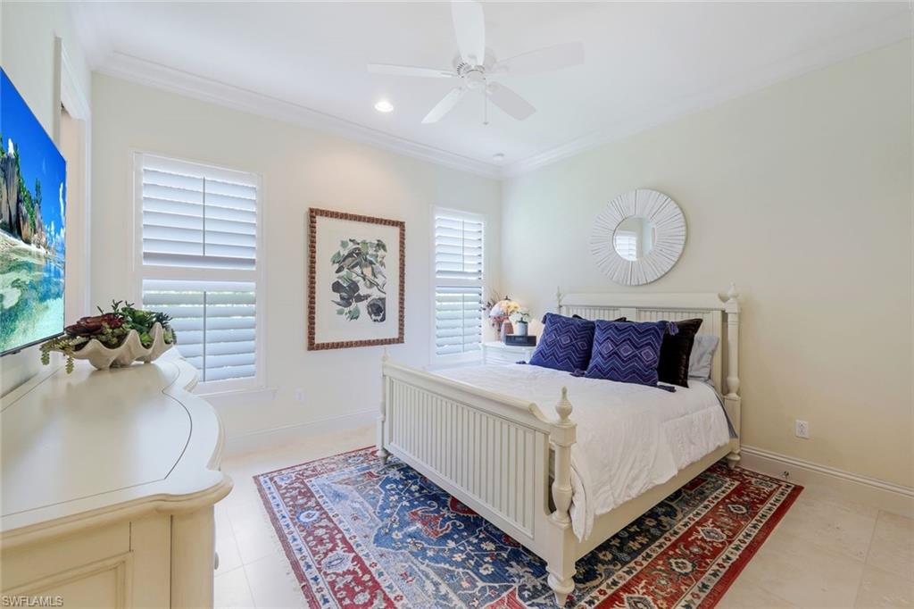 9243 Marble Stone Drive Naples, FL 34120 - Photo 29 of 50 a bed room with a bed and a chandelier