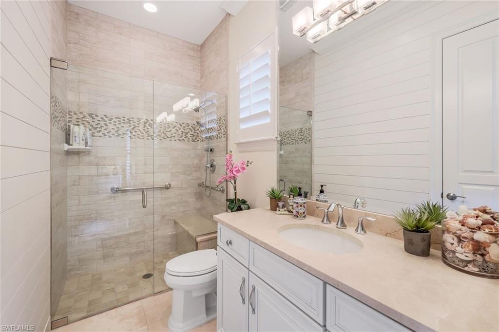 9243 Marble Stone Drive Naples, FL 34120 - Photo 30 of 50 a bathroom with a sink a toilet and a shower