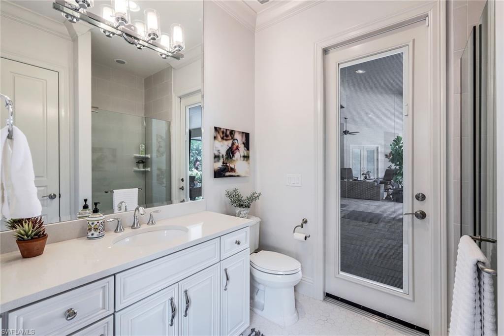 9243 Marble Stone Drive Naples, FL 34120 - Photo 34 of 50 a bathroom with a granite countertop sink a toilet and shower