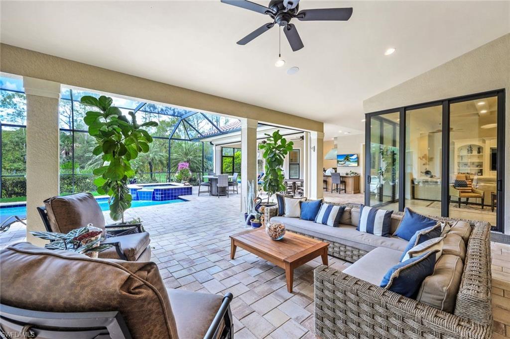 9243 Marble Stone Drive Naples, FL 34120 - Photo 37 of 50 a living room with furniture and a large window
