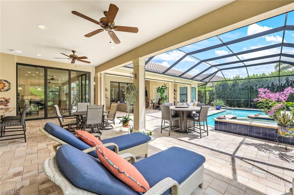 9243 Marble Stone Drive Naples, FL 34120 - Photo 39 of 50 a living room with furniture floor to ceiling window and wooden floor