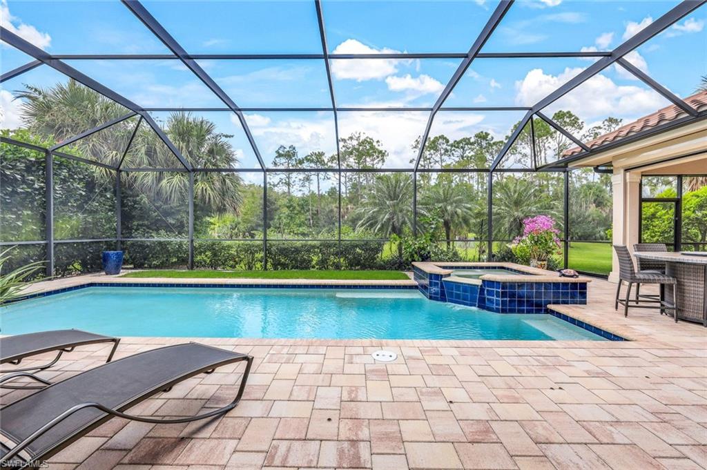9243 Marble Stone Drive Naples, FL 34120 - Photo 44 of 50 a backyard of a house with outdoor seating
