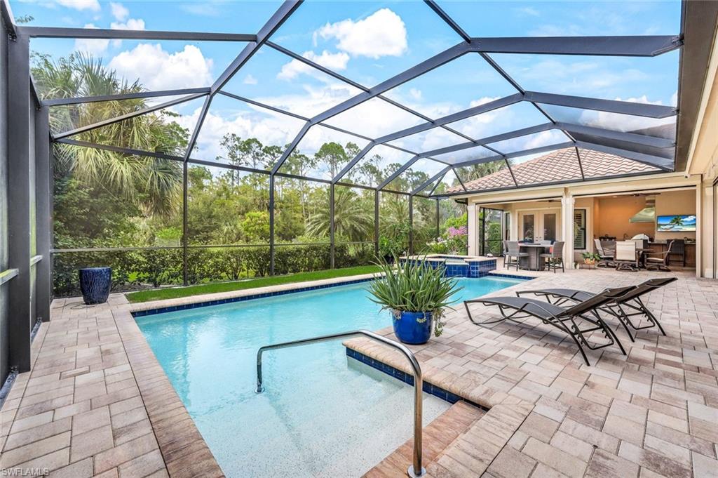 9243 Marble Stone Drive Naples, FL 34120 - Photo 46 of 50 a view of a swimming pool with a patio