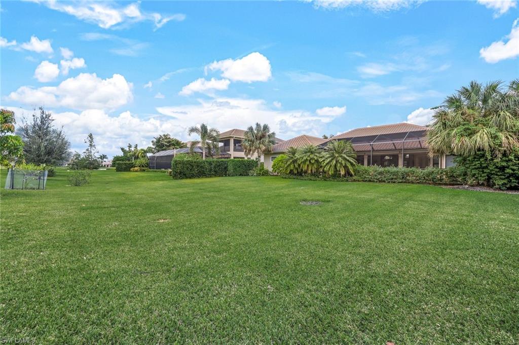 9243 Marble Stone Drive Naples, FL 34120 - Photo 48 of 50 a view of a big yard with a house in the background