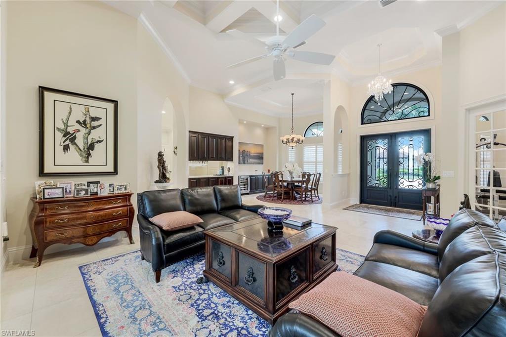 9243 Marble Stone Drive Naples, FL 34120 - Photo 8 of 50 a living room with furniture fireplace and a window