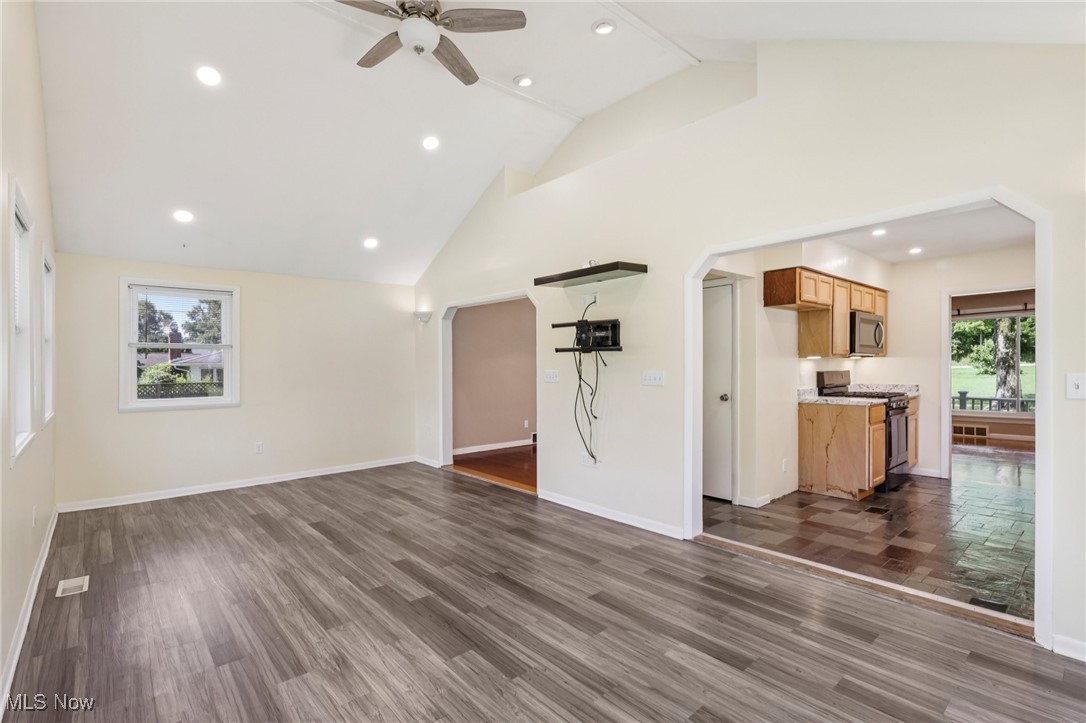 5097 Chillicothe Road Chagrin Falls, OH 44022 - Photo 15 of 45 Unfurnished living room with arched walkways, recessed lighting, a ceiling fan, dark wood-style floors, and high vaulted ceiling