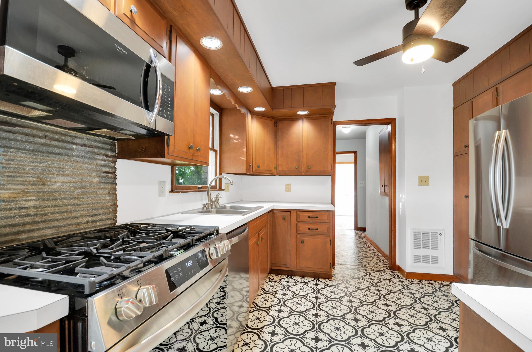221 Hartman Road Reading, PA 19606 - Photo 15 of 29 a kitchen with stainless steel appliances granite countertop a stove a sink and a refrigerator