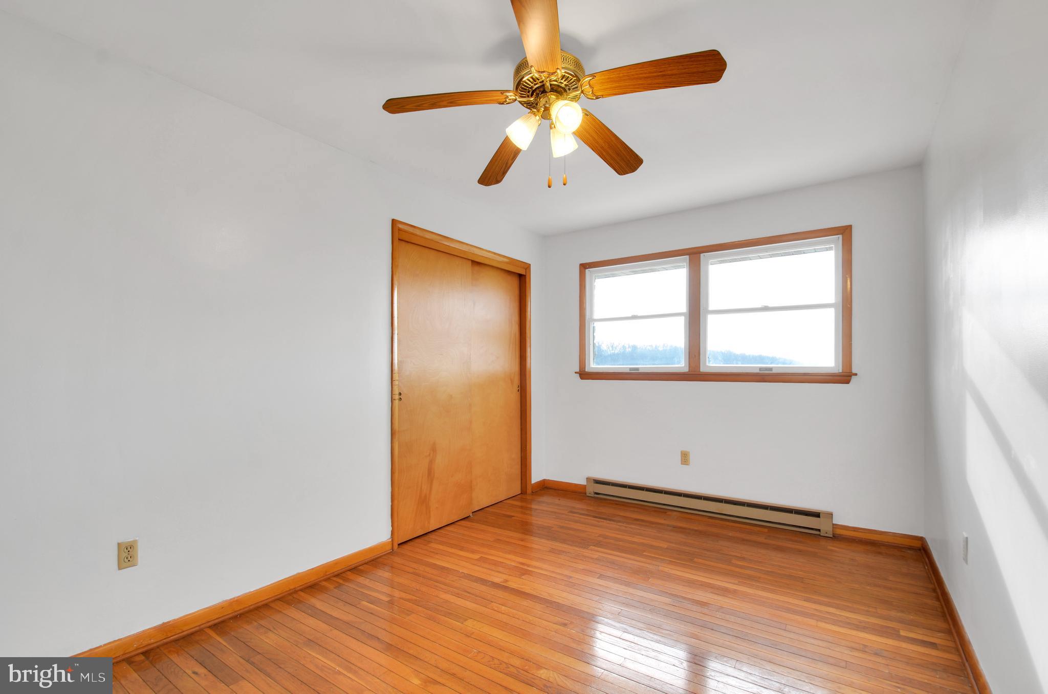 221 Hartman Road Reading, PA 19606 - Photo 16 of 29 a view of empty room with wooden floor and fan