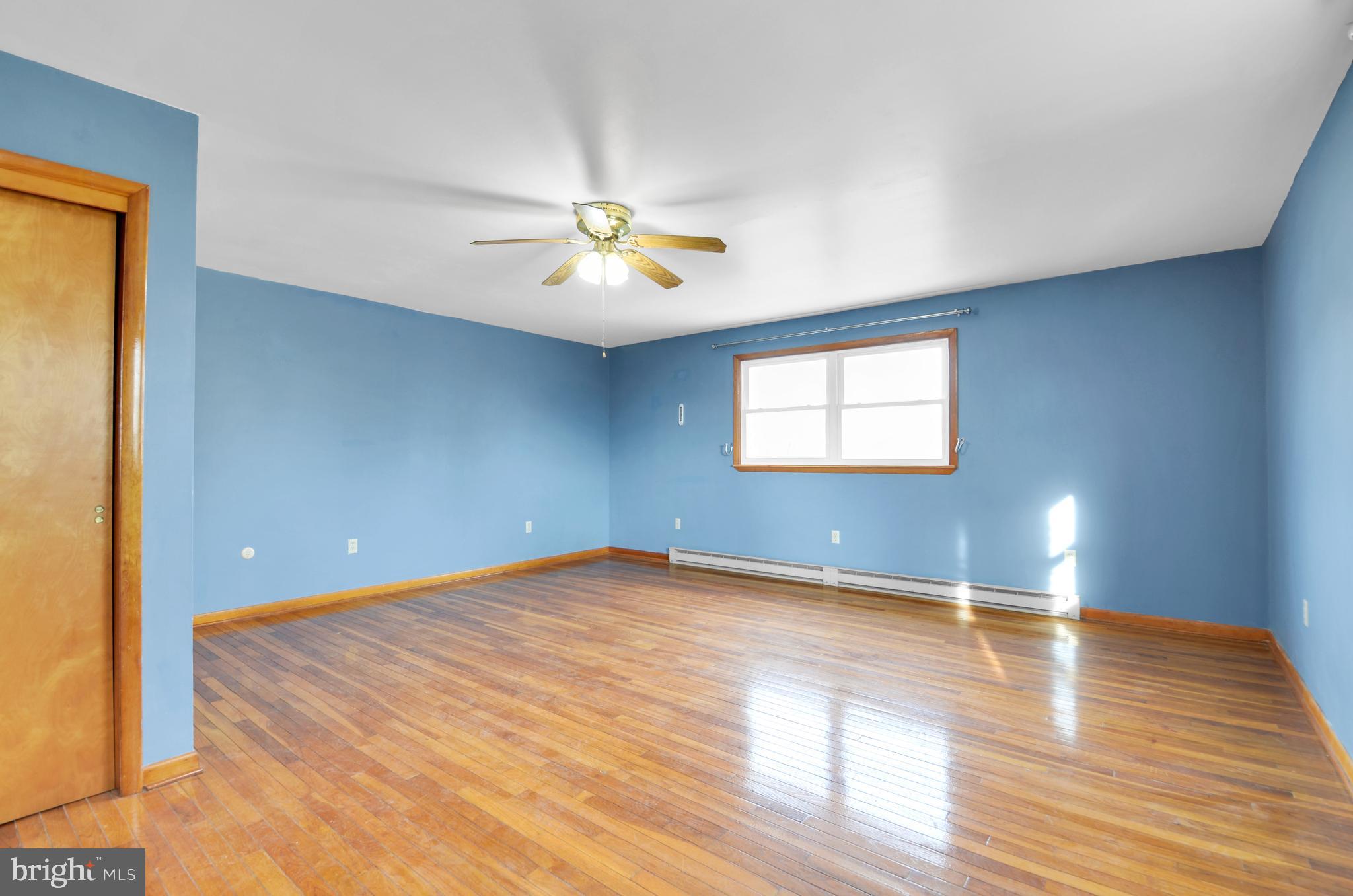 221 Hartman Road Reading, PA 19606 - Photo 17 of 29 an empty room with wooden floor and windows