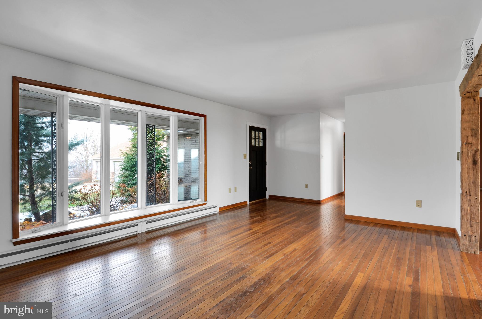 221 Hartman Road Reading, PA 19606 - Photo 9 of 29 a view of an empty room with wooden floor and a window