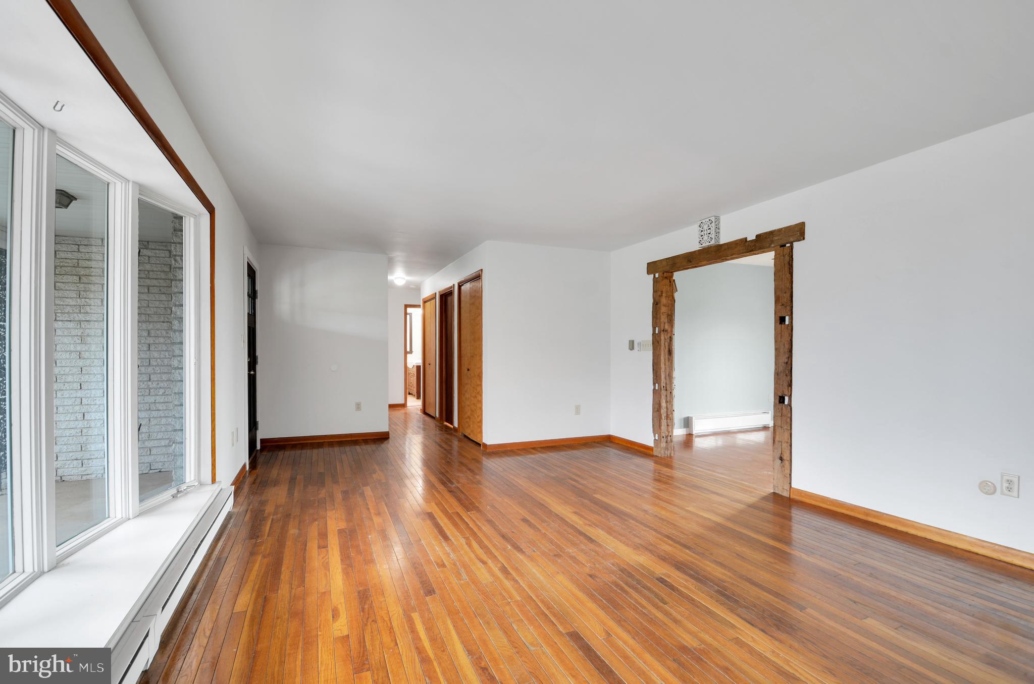 221 Hartman Road Reading, PA 19606 - Photo 10 of 29 a view of an empty room with wooden floor and a window