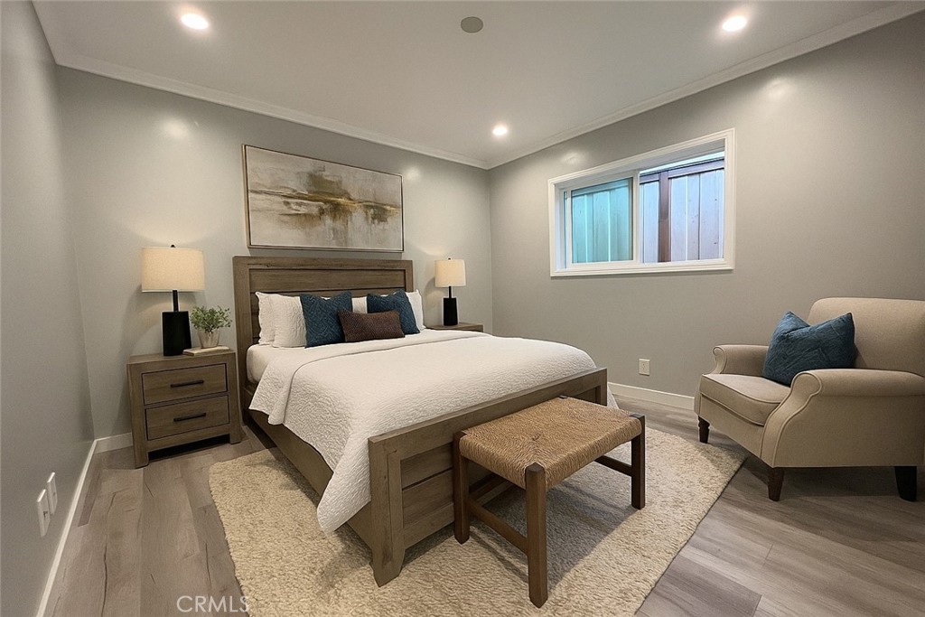 457 Seaward Road, Unit B Newport Beach, CA 92625 - Photo 9 of 16 a bedroom with a bed and wooden floor