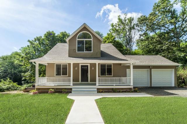 38 Georgetown Road Weston, CT 06883 - Photo 1 of 1 a front view of a house with a garden