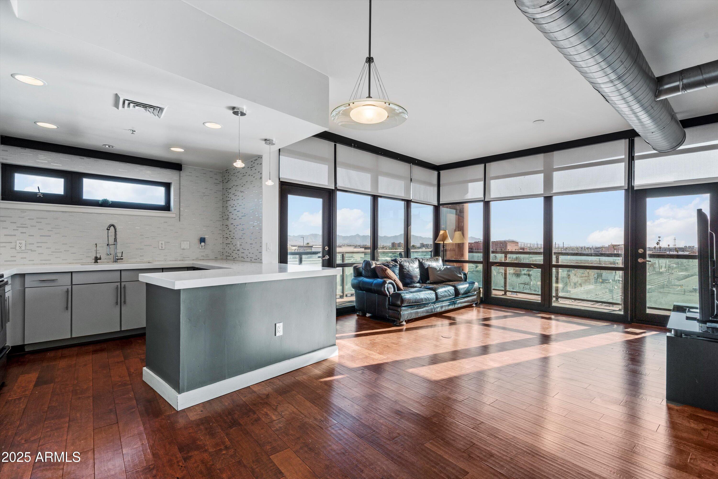 310 South 4th Street, Unit 601 Phoenix, AZ 85004 - Photo 2 of 32 a living room with stainless steel appliances granite countertop a sink window and wooden floor