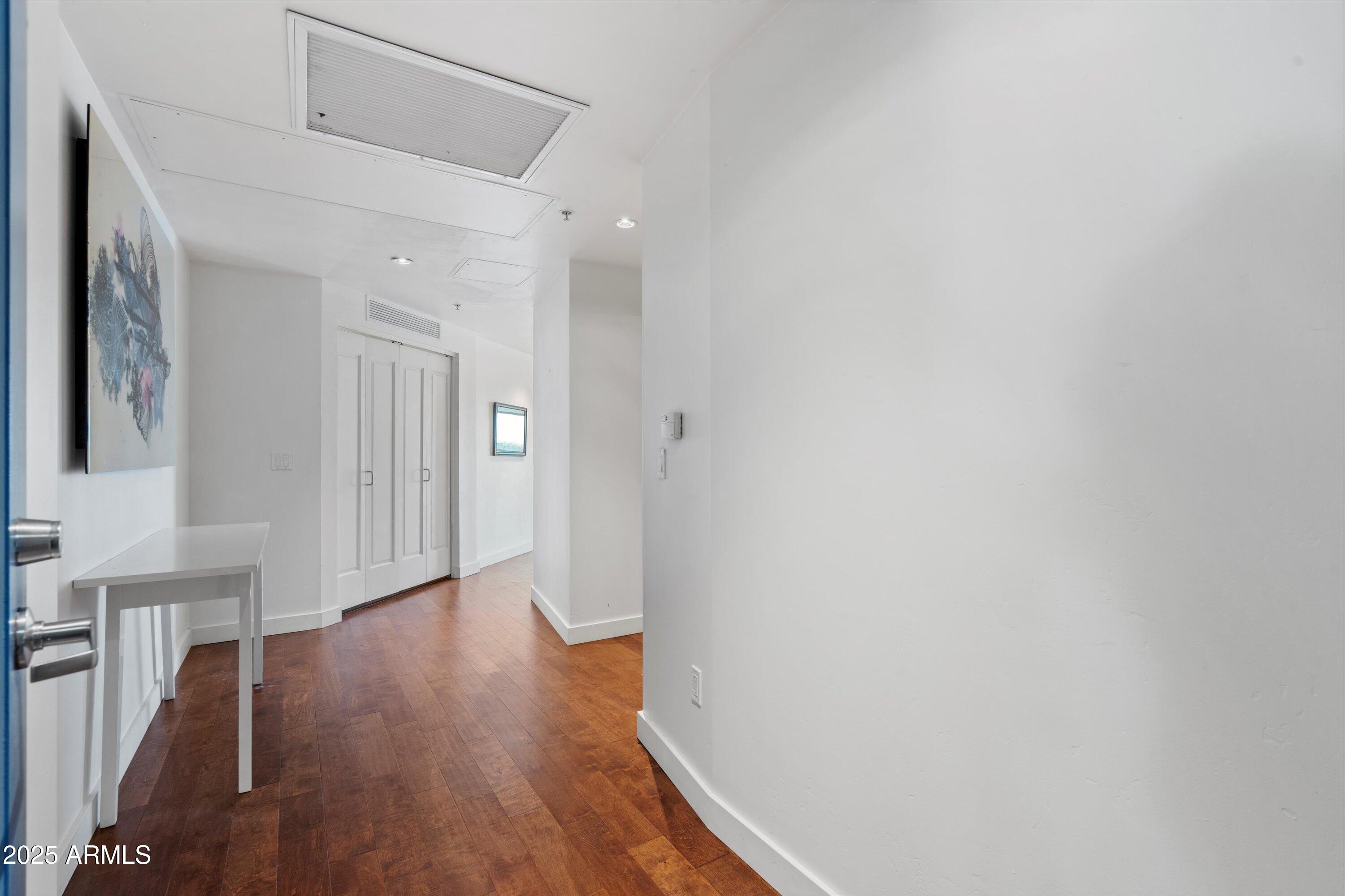 310 South 4th Street, Unit 601 Phoenix, AZ 85004 - Photo 3 of 32 a view of a hallway with wooden floor
