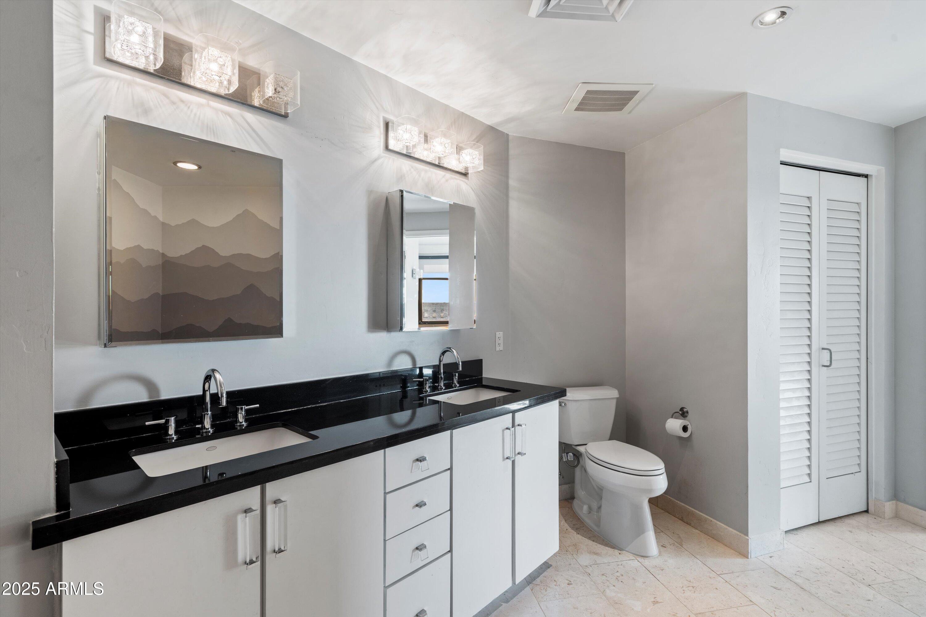 310 South 4th Street, Unit 601 Phoenix, AZ 85004 - Photo 10 of 32 a bathroom with double sink and a large mirror