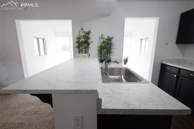 a kitchen with a sink and a stove top oven