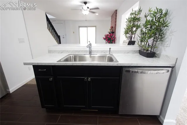 a kitchen with a sink and wooden floor