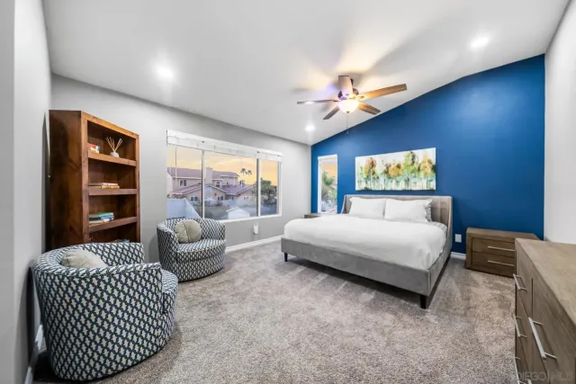 a spacious bedroom with a bed and a couch