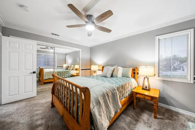 a bedroom with a bed and a large window