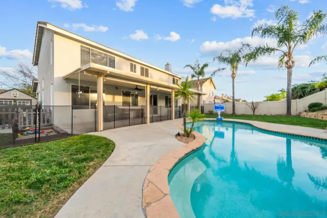 a view of a house with swimming pool and sitting area