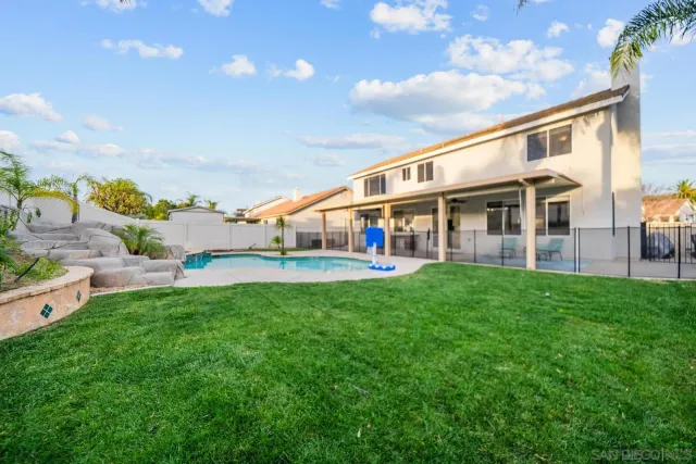 a view of an house with backyard porch and sitting area