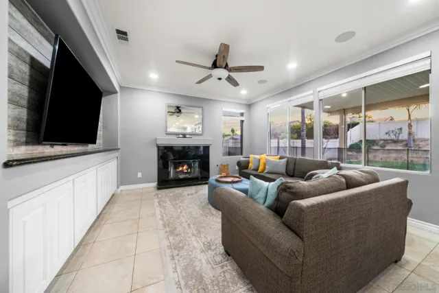 a living room with furniture a flat screen tv and a fireplace