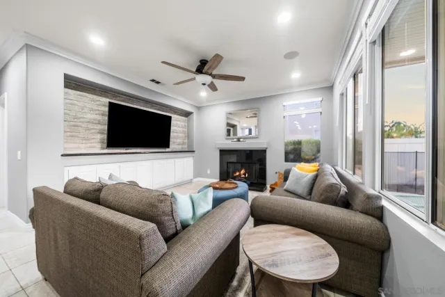 a living room with furniture a fireplace and a flat screen tv