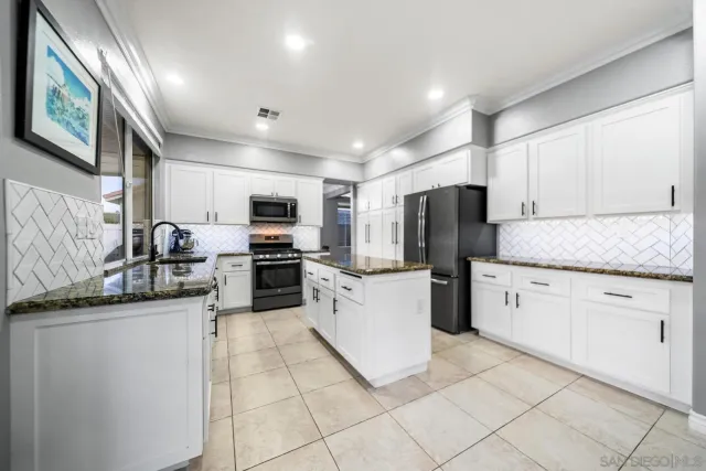 a kitchen with a sink cabinets and stainless steel appliances