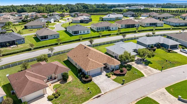 an aerial view of a house with a swimming pool yard and outdoor seating