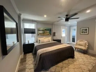 a bedroom with a large bed and a chandelier