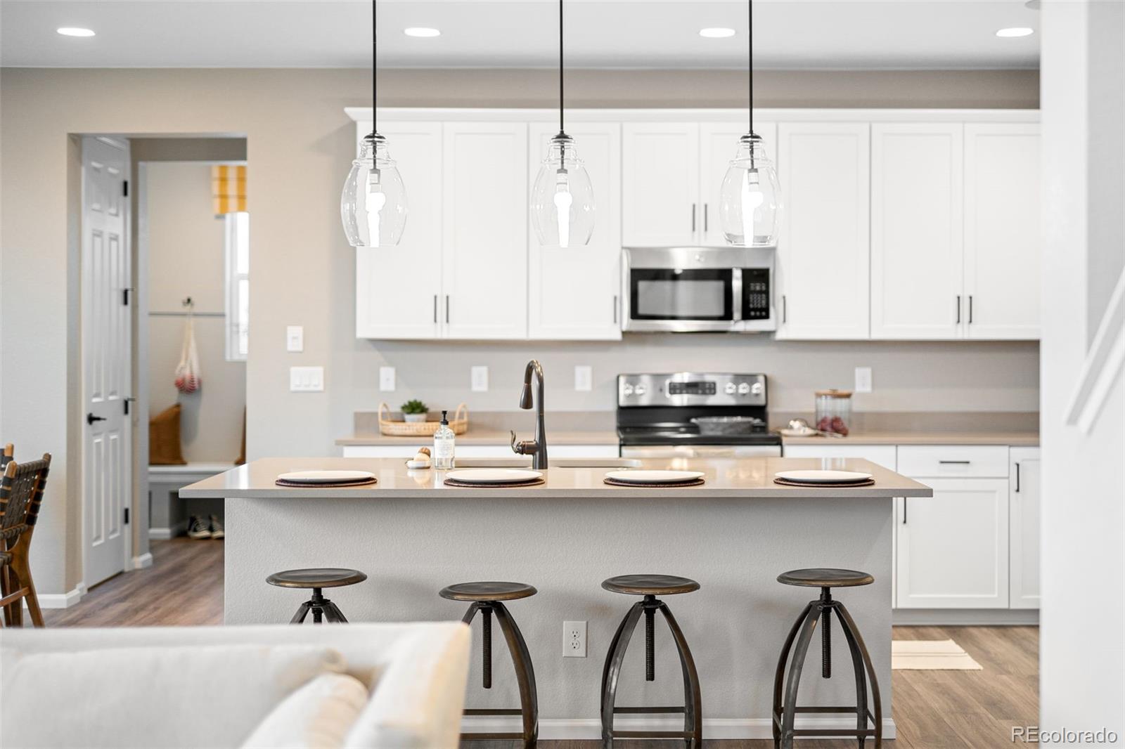 3957 Breakcamp Court Castle Rock, CO 80108 - Photo 12 of 50 a kitchen with stainless steel appliances kitchen island a white counter top space cabinets and a potted plant