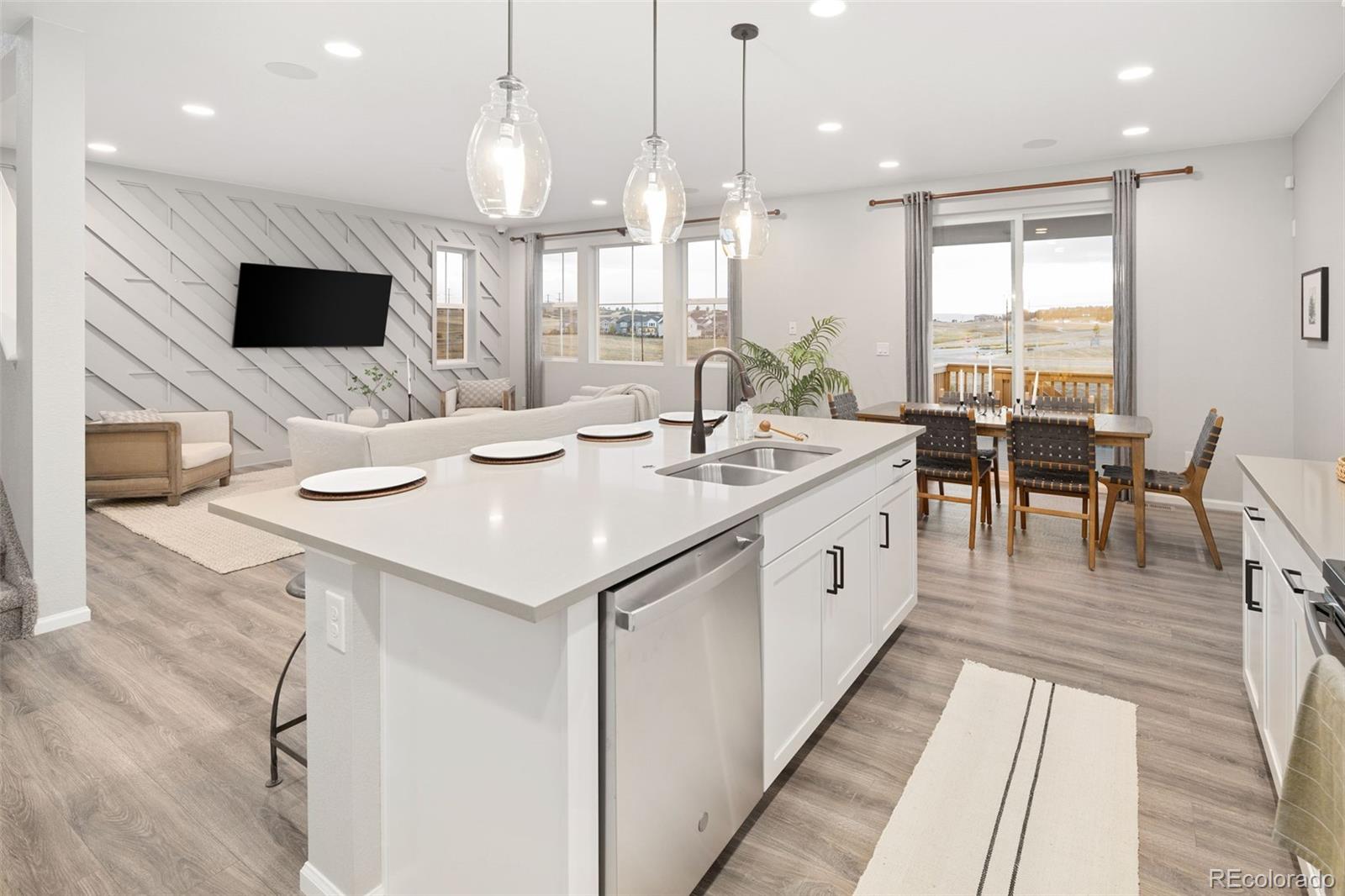 3957 Breakcamp Court Castle Rock, CO 80108 - Photo 14 of 50 a large white kitchen with a large window and stainless steel appliances