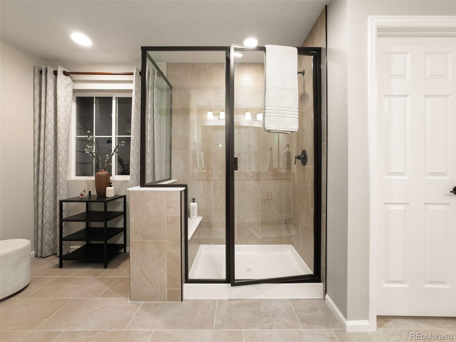 3957 Breakcamp Court Castle Rock, CO 80108 - Photo 26 of 50 a bathroom with a glass shower door