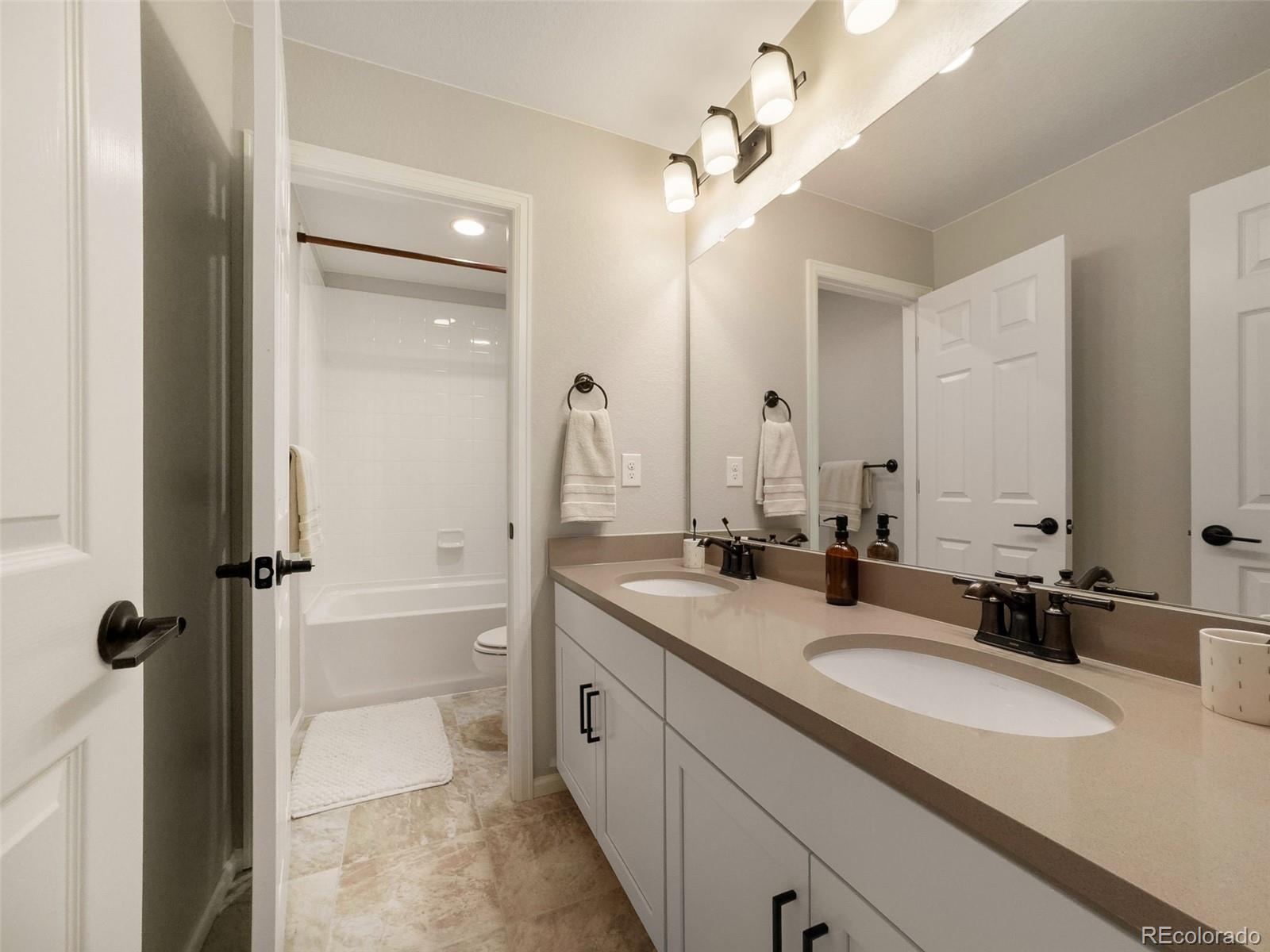 3957 Breakcamp Court Castle Rock, CO 80108 - Photo 27 of 50 a bathroom with a sink double vanity granite tub and shower