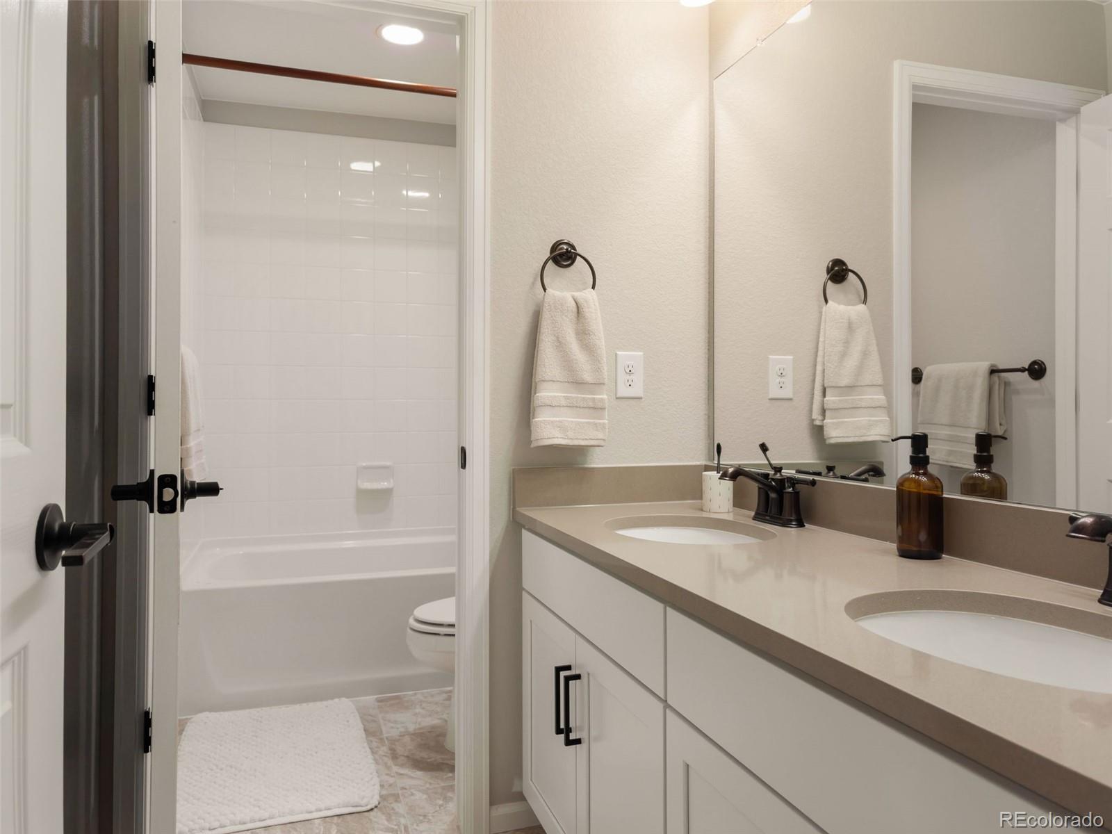 3957 Breakcamp Court Castle Rock, CO 80108 - Photo 28 of 50 a bathroom with a granite countertop sink toilet and shower