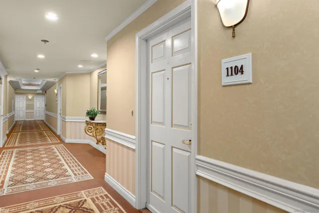 a living room with furniture a flat screen tv and a large window