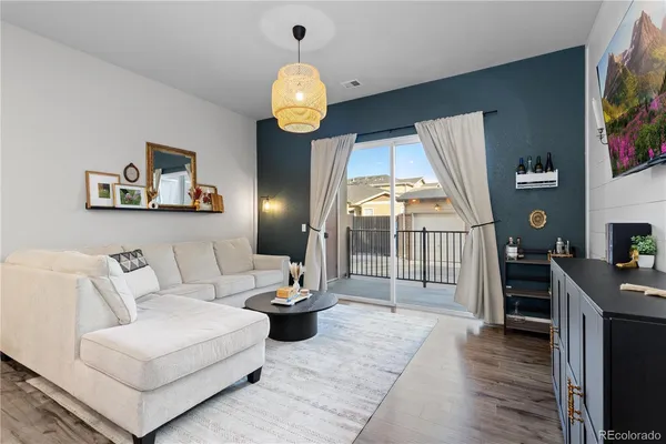 a living room with furniture and a flat screen tv