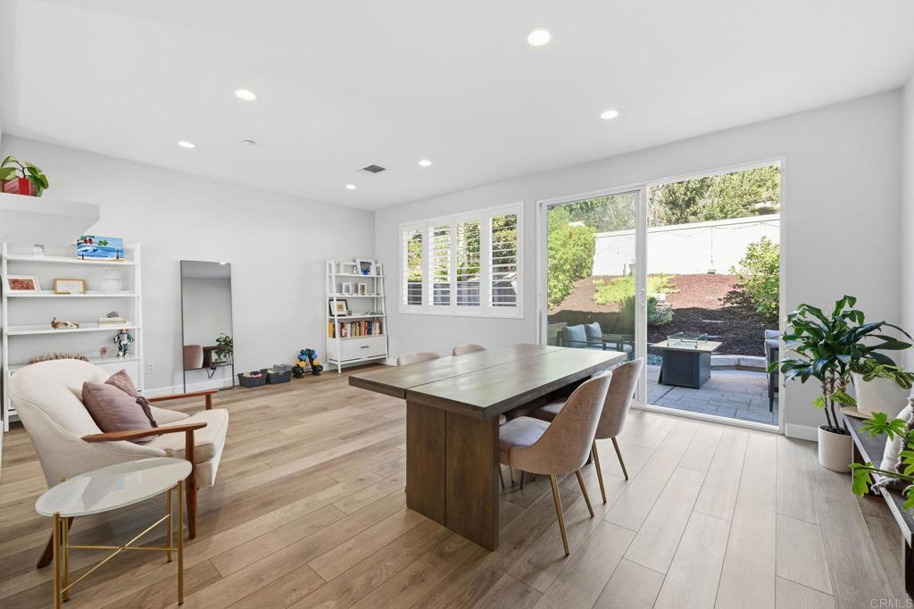 6485 Alexandri Circle Carlsbad, CA 92011 - Photo 11 of 40 a living room with furniture a large window and wooden floor