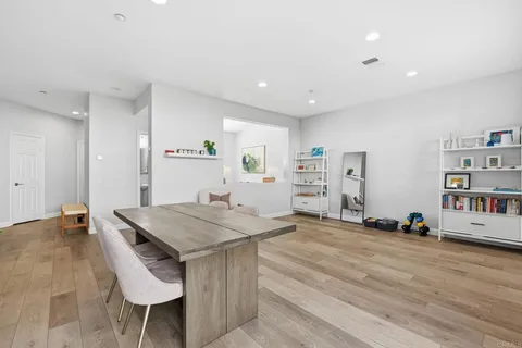 a view of a kitchen with furniture and wooden floor