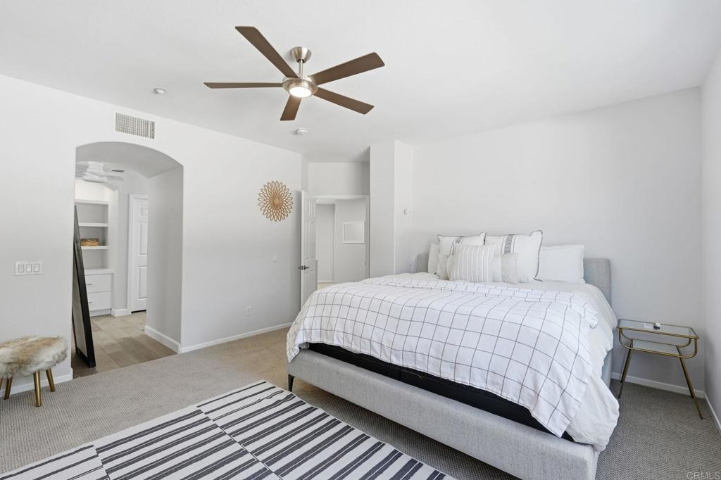 6485 Alexandri Circle Carlsbad, CA 92011 - Photo 19 of 40 a bedroom with a large bed and a chandelier