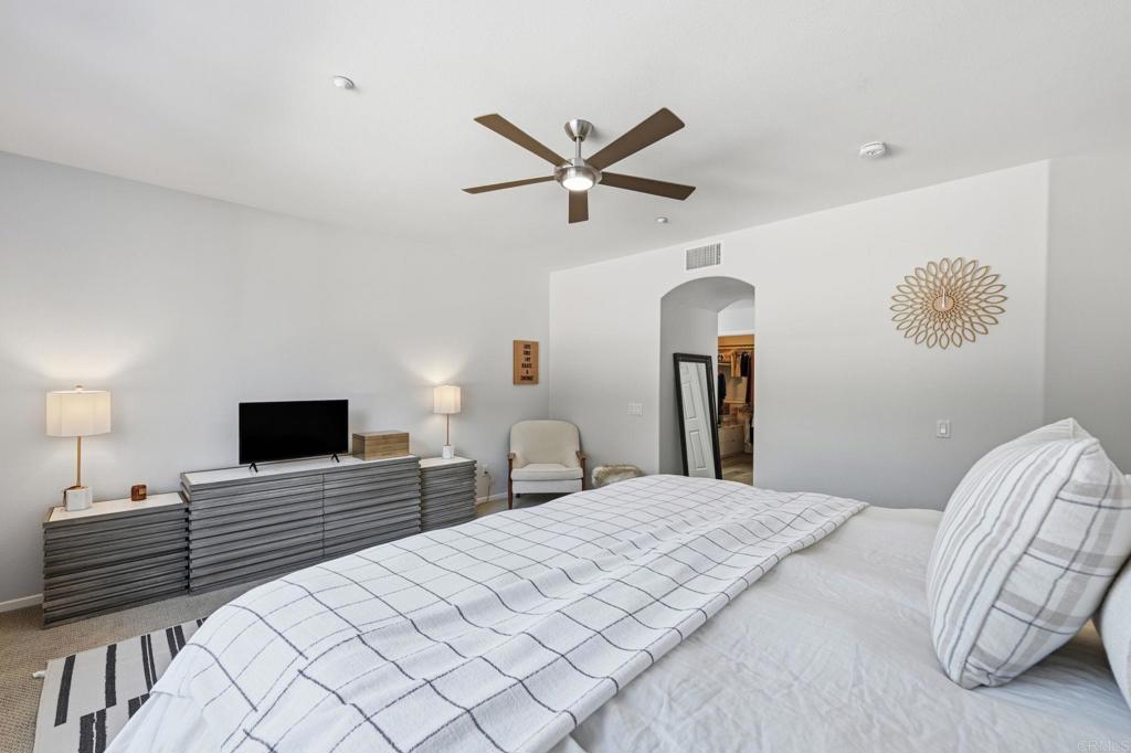 6485 Alexandri Circle Carlsbad, CA 92011 - Photo 20 of 40 a bedroom with a bed and a flat screen tv
