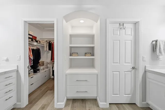 a view of walk in closet with clothes