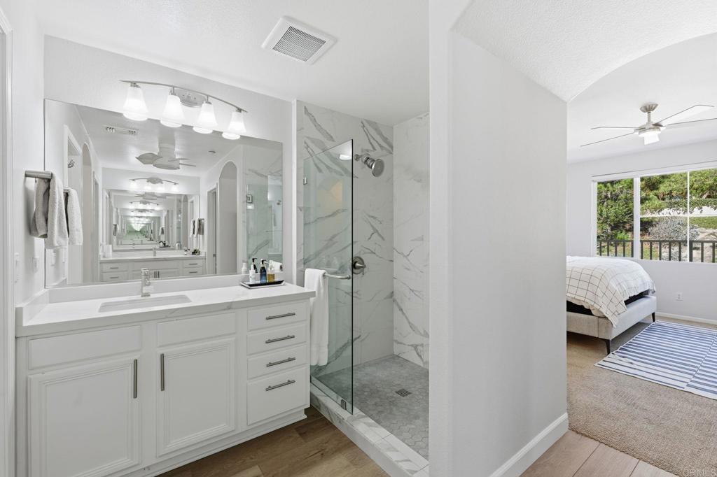 6485 Alexandri Circle Carlsbad, CA 92011 - Photo 22 of 40 a en suite bathroom with a double vanity sink and mirror