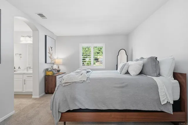 a bedroom with a bed and a dresser