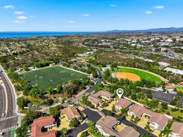 an aerial view of residential houses with outdoor space
