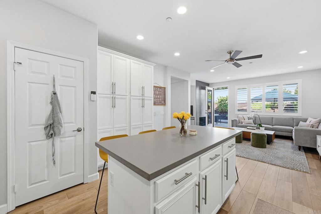 6485 Alexandri Circle Carlsbad, CA 92011 - Photo 5 of 40 a kitchen with stainless steel appliances granite countertop a sink a counter space and a living room view