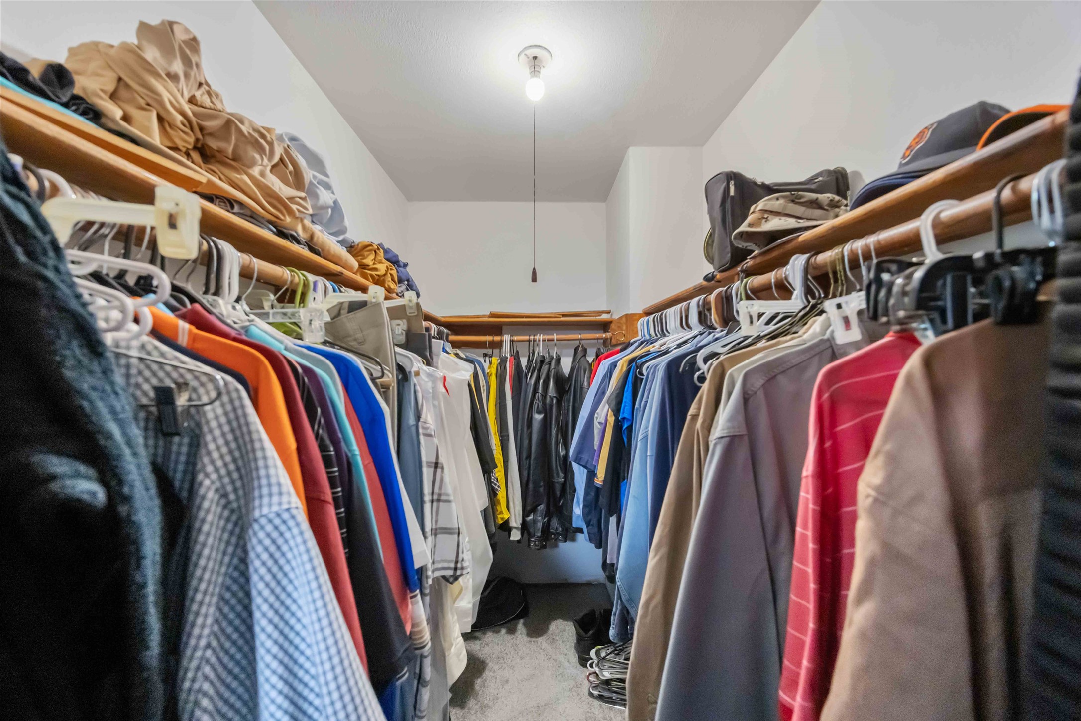 615 Massey Tompkins Road Baytown, TX 77521 - Photo 12 of 25 a view of walk in closet with clothes and shoes