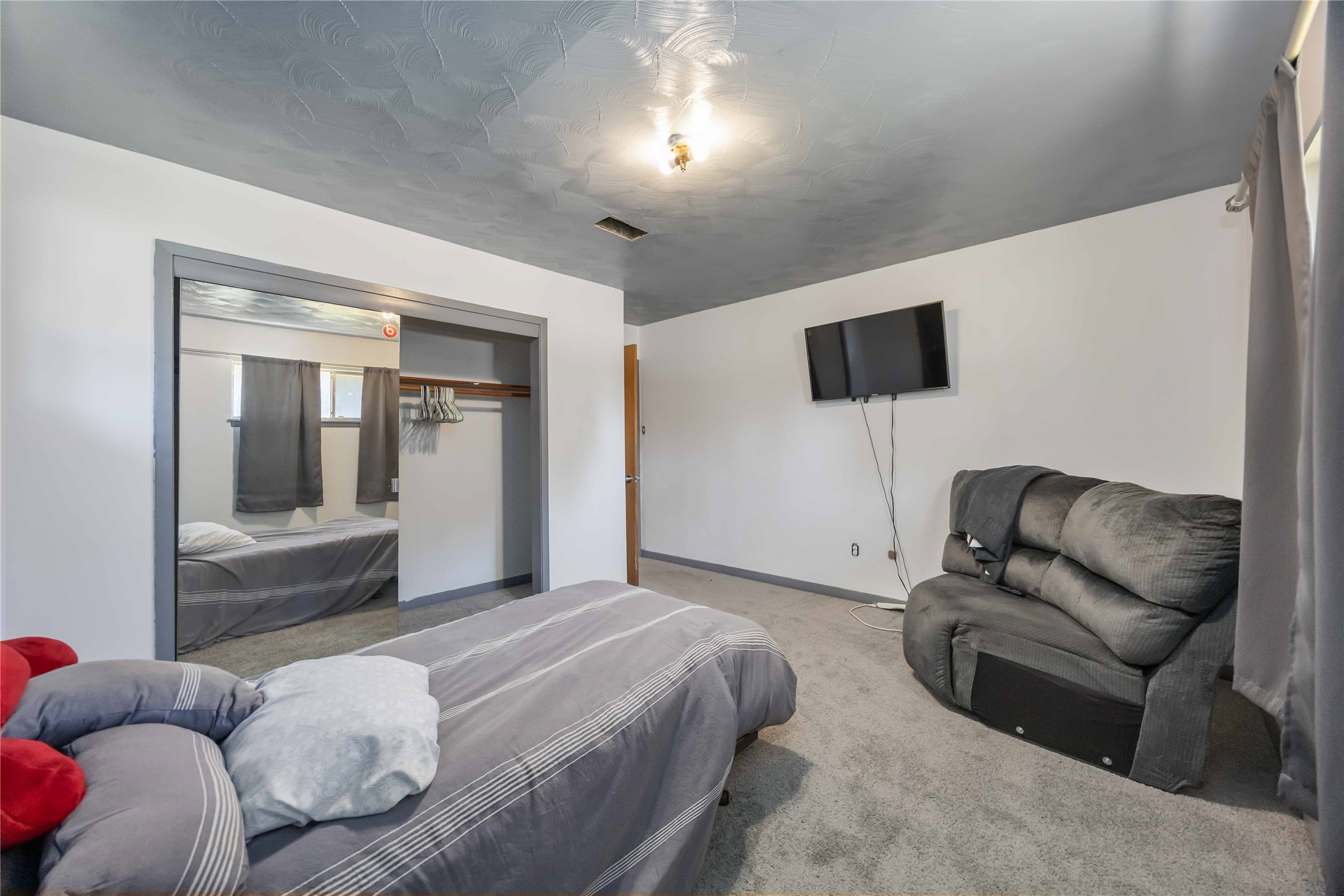 615 Massey Tompkins Road Baytown, TX 77521 - Photo 15 of 25 a bedroom with a bed and a couch