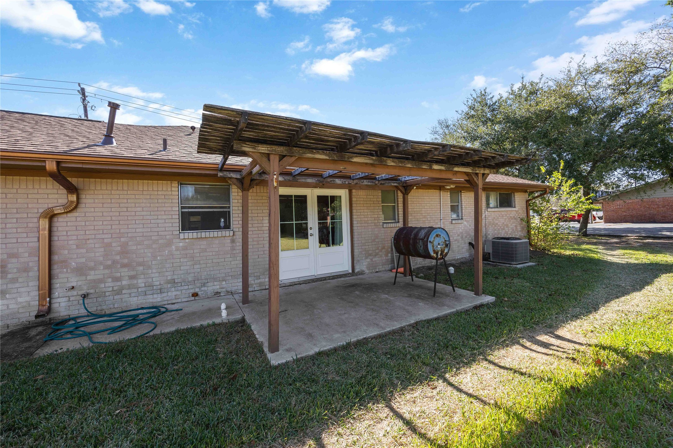 615 Massey Tompkins Road Baytown, TX 77521 - Photo 21 of 25 a view of a house with backyard sitting area and garden